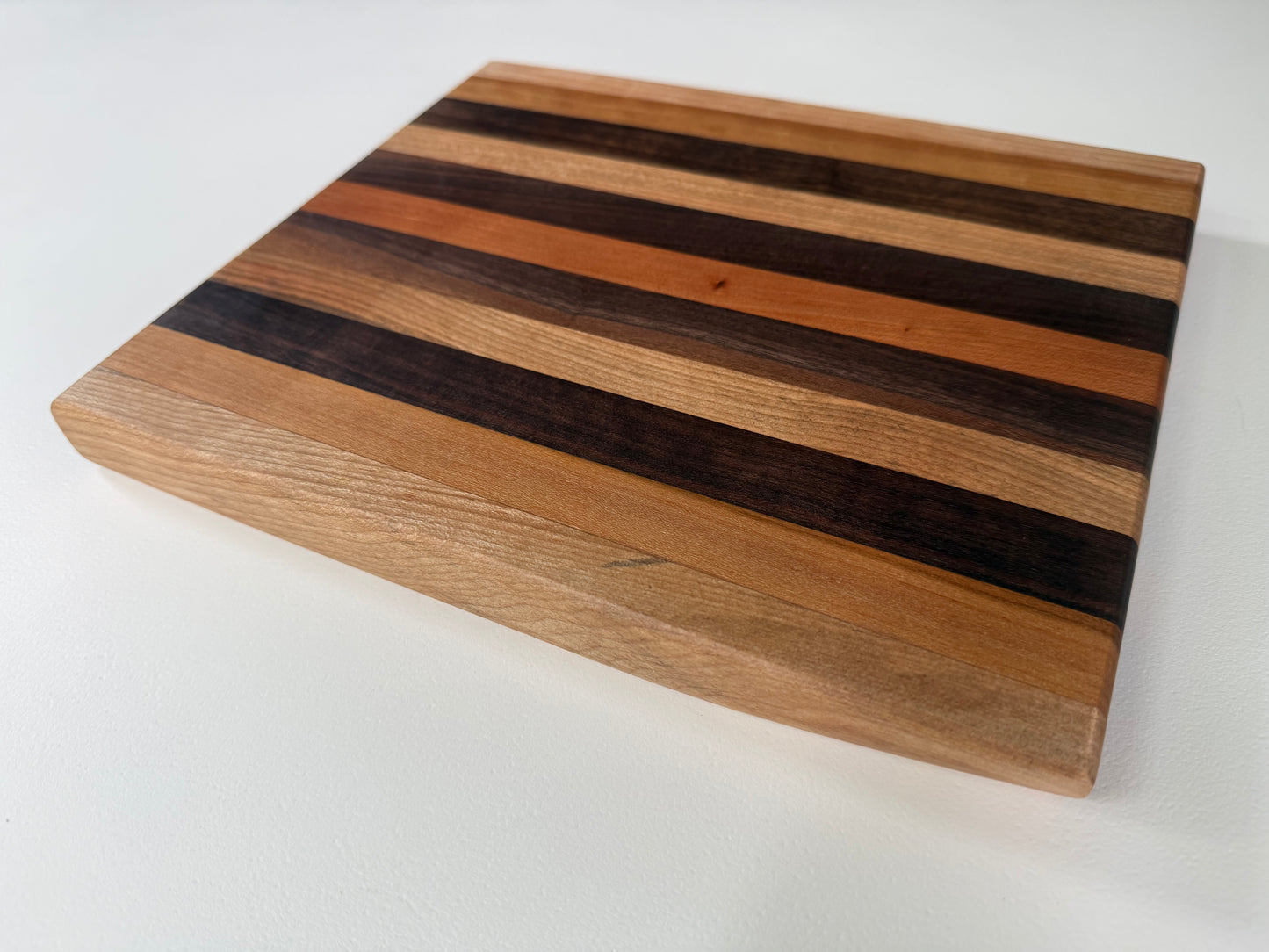 Wooden cutting board with striped pattern on a white background
