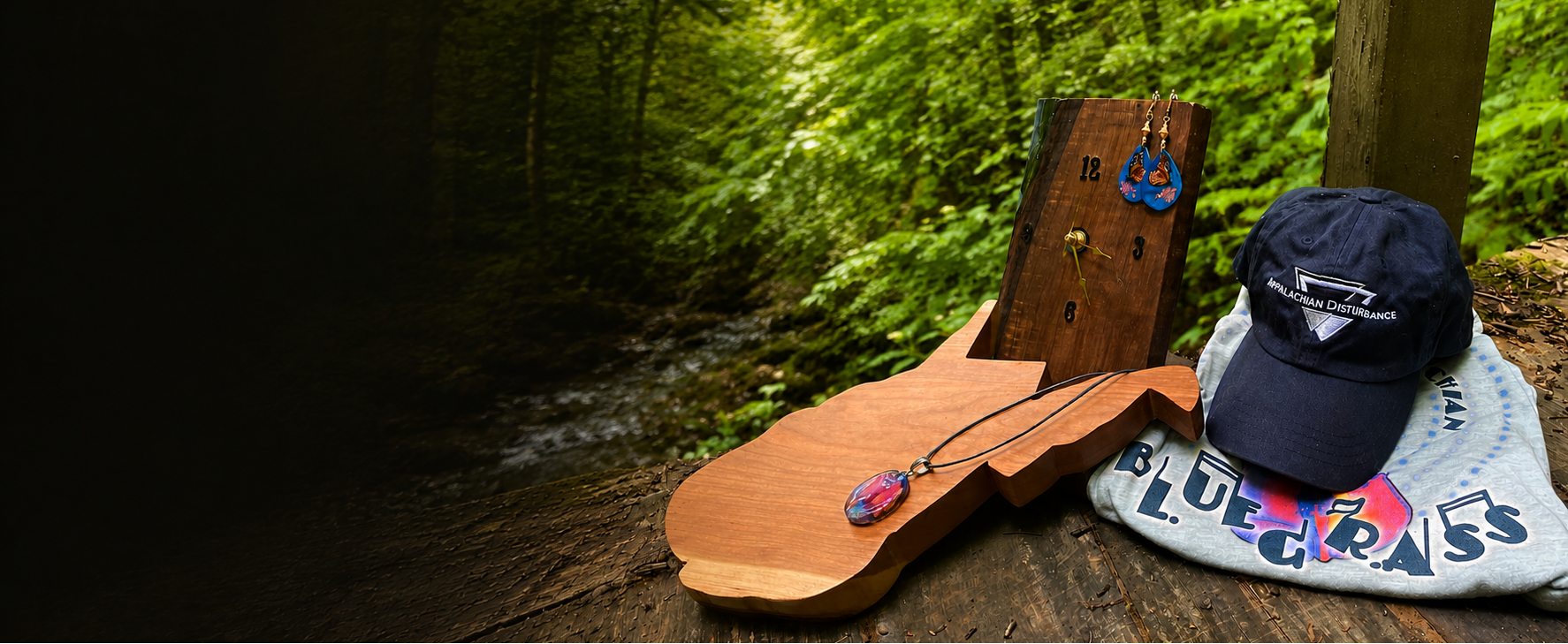 Wooden clock and charcuterie board, hat, t-shirt, earrings, and necklace on a wooden bridge in a forest