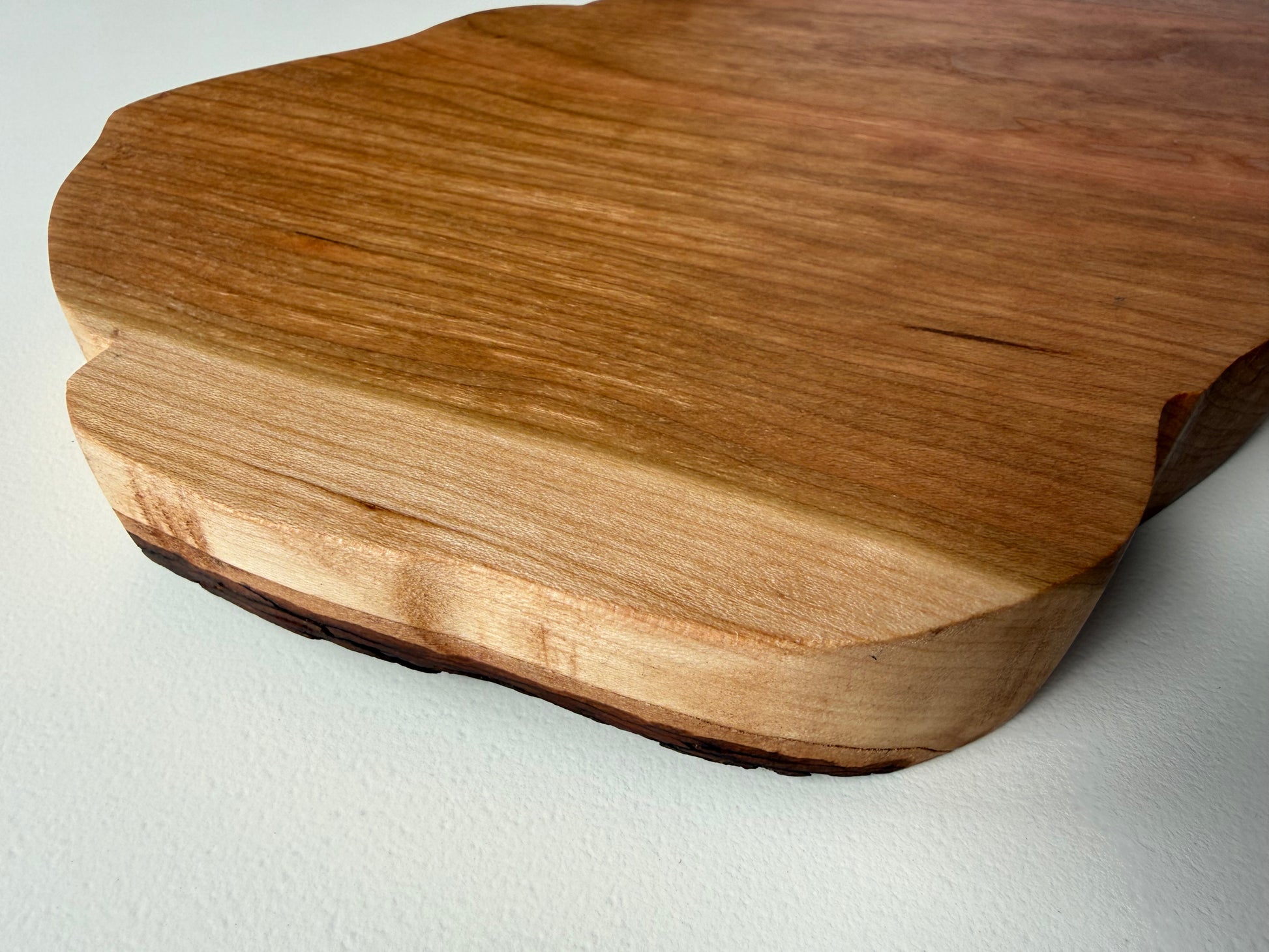 West Virginia shaped charcuterie board. Partial view of edge.