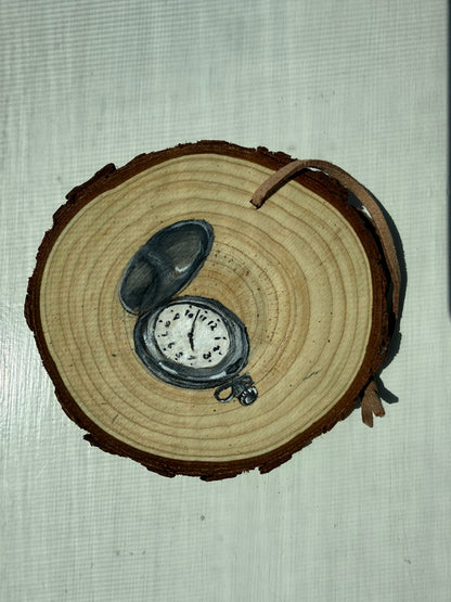 Wooden ornament with a painted pocket watch on it
