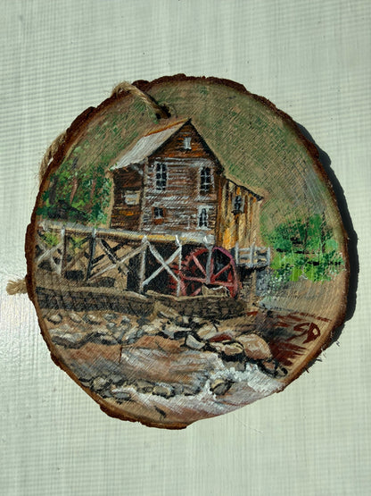 Wooden ornament with a painted scene of a mill