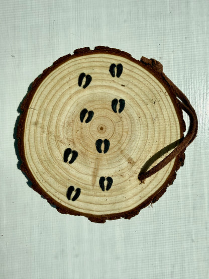 Wooden ornament showcasing bison hoofprints 