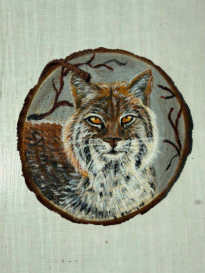Wooden ornament featuring a hand-painted bobcat 