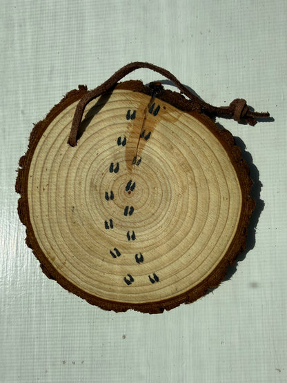 Wooden ornament showcasing bison footprints