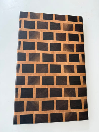 Wooden cutting board with a geometric pattern on a white surface