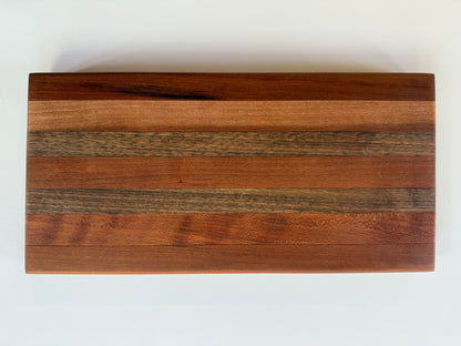 Wooden cutting board with a stripe pattern on a white surface