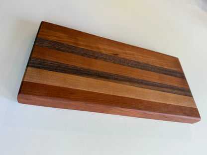 Wooden cutting board with a stripe pattern on a white surface