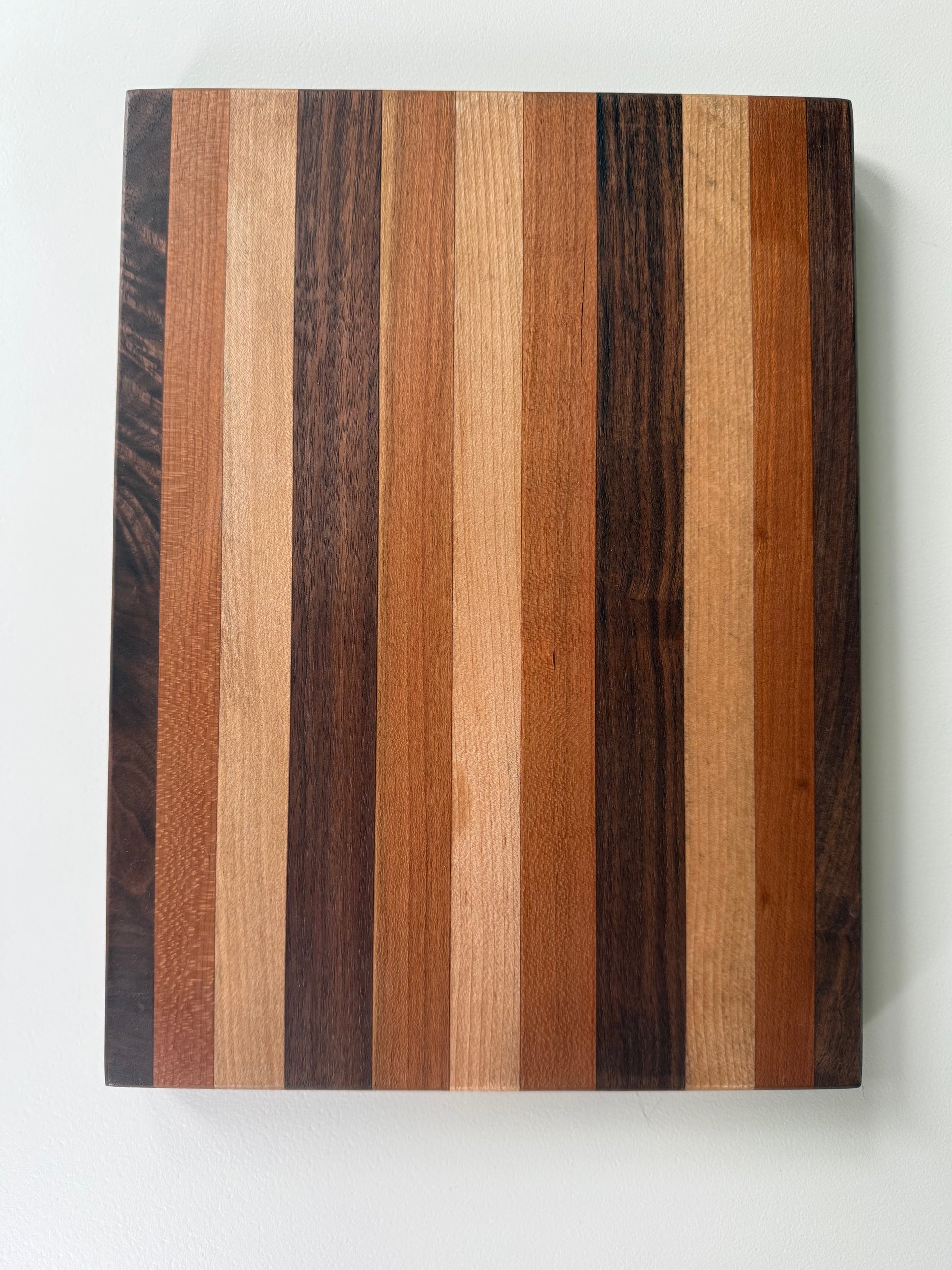 Wooden cutting board with striped pattern on a white background