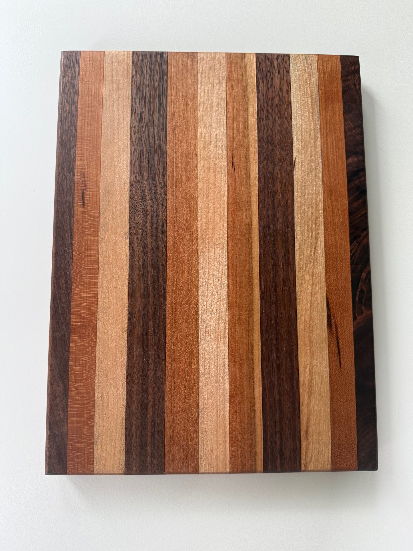 Wooden cutting board with striped pattern on a white background