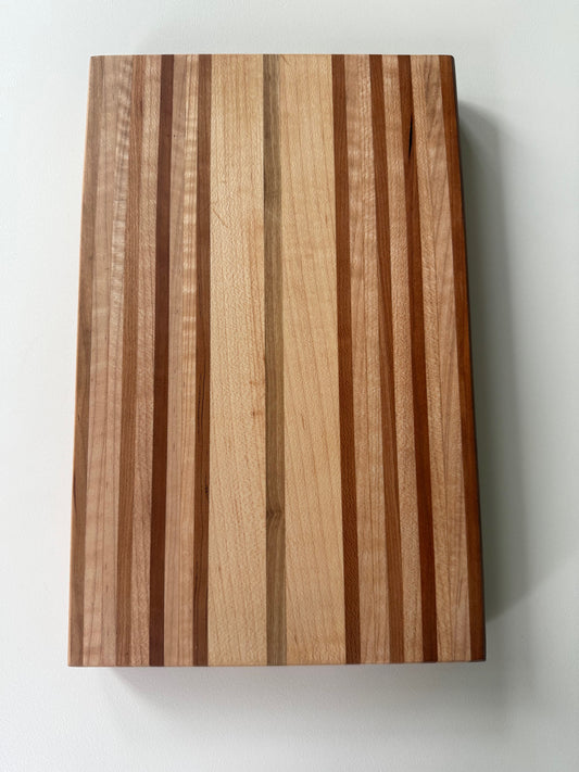 Wooden cutting board with striped pattern on a white background