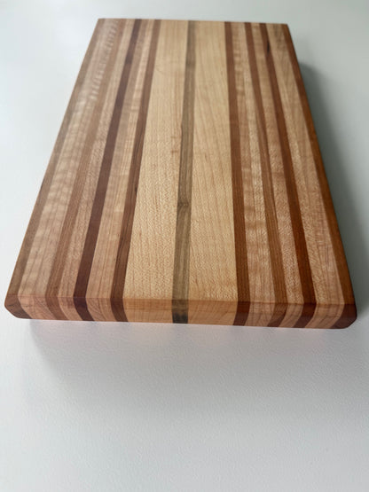 Wooden cutting board with striped pattern on a white background