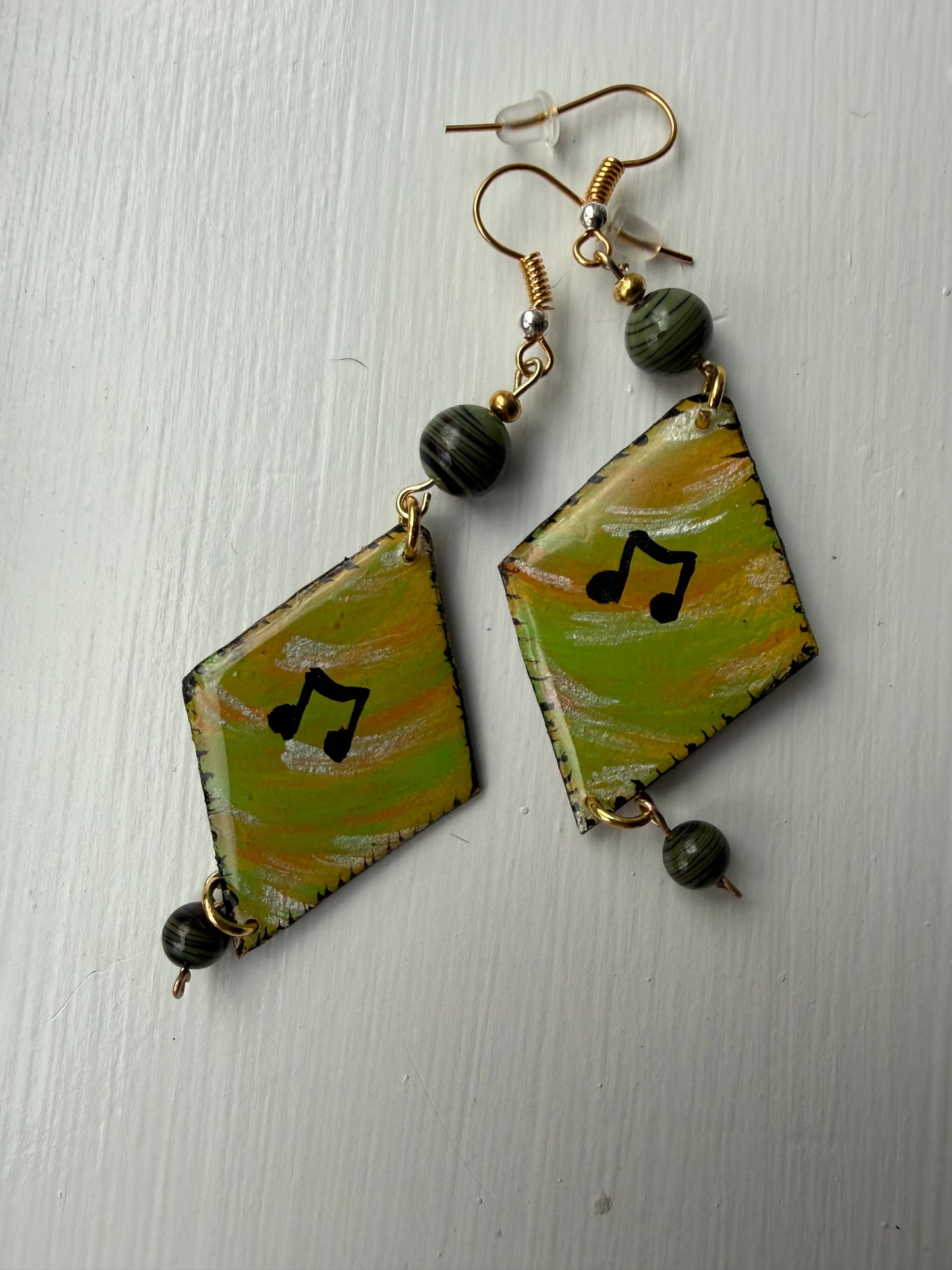 Pair of earrings with music note on each one