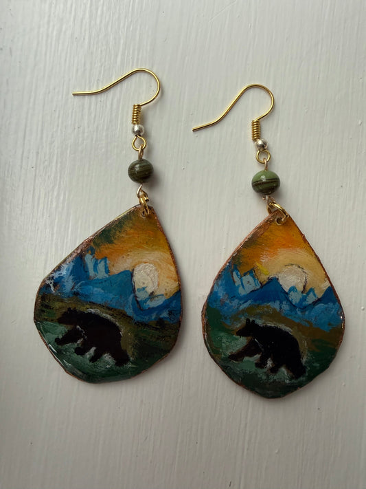 Pair of earrings with an artistic design of a black bear on each one