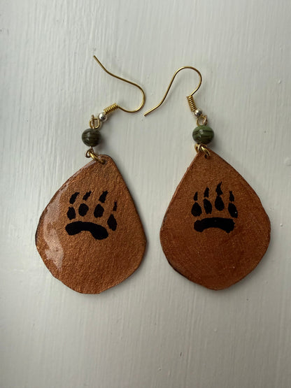 Pair of earrings with an artistic design of a bear paw on each one