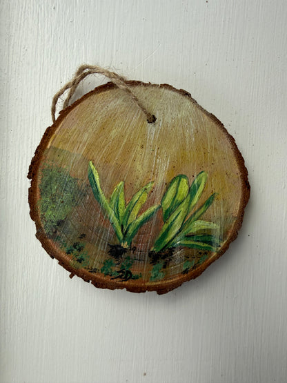 Wooden ornament with painted ramp leaves on a white background