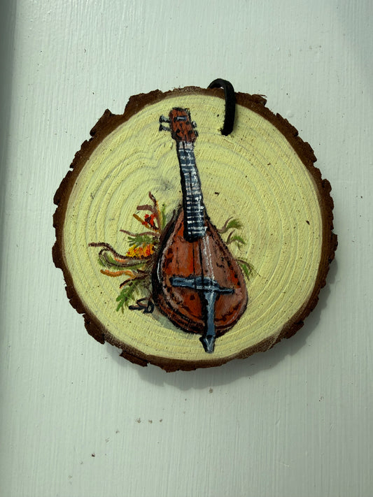 Wooden ornament with a painted mandolin design on it