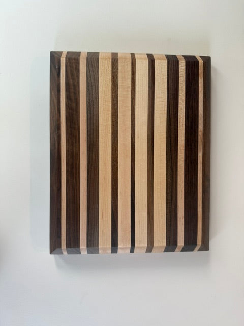 Wooden cutting board with striped pattern on a white background