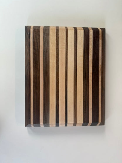 Wooden cutting board with striped pattern on a white background