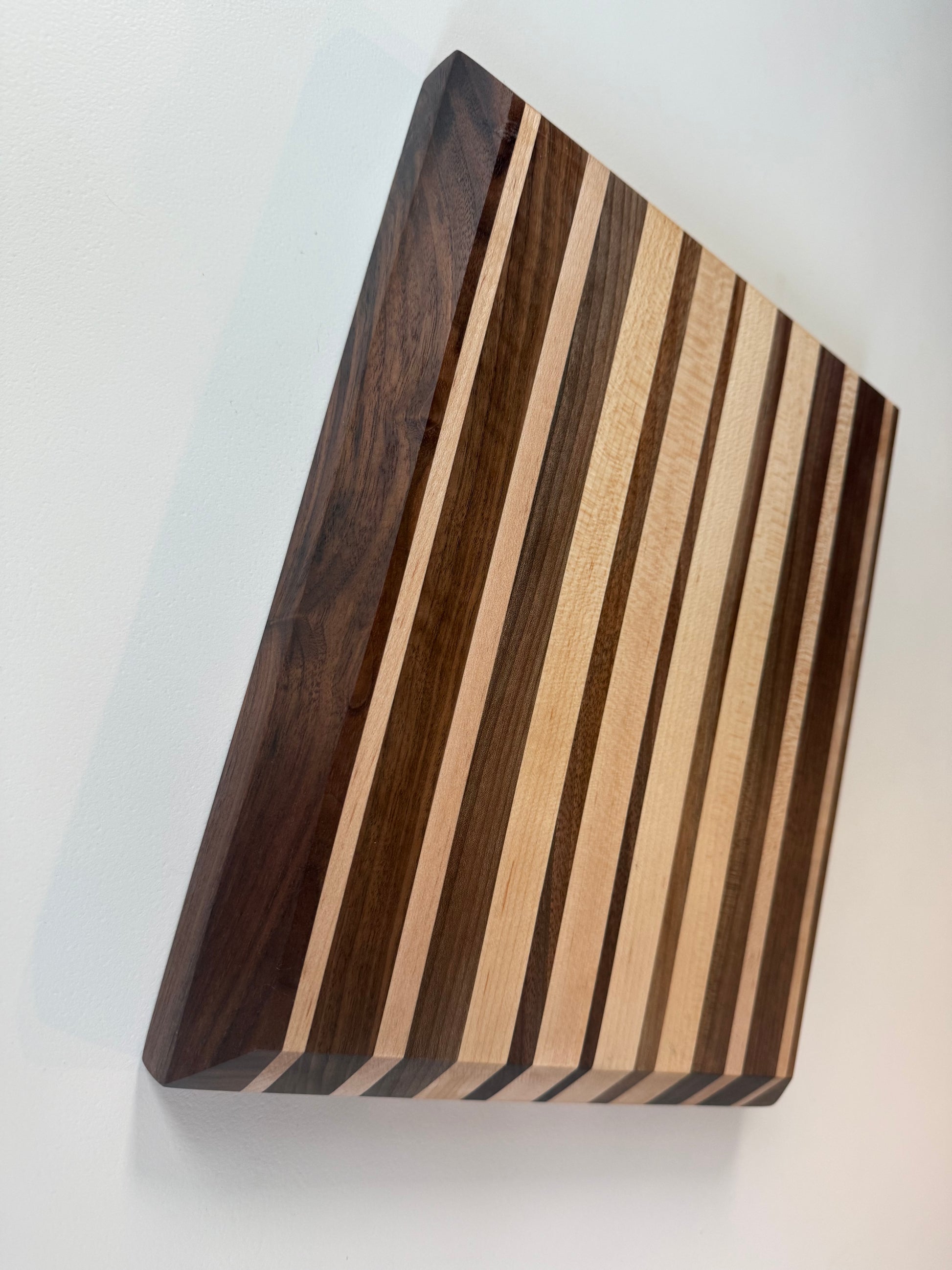 Wooden cutting board with striped pattern on a white background