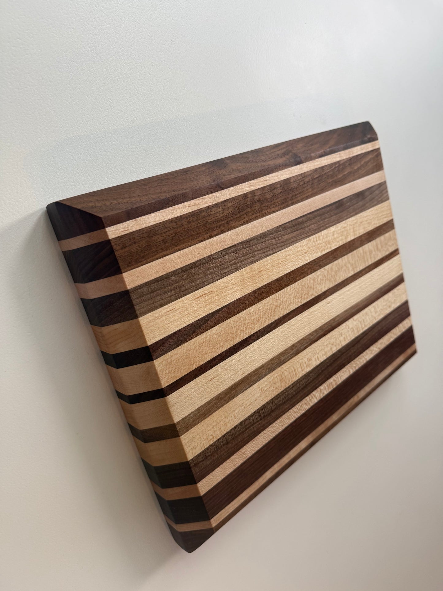 Wooden cutting board with striped pattern on a white background