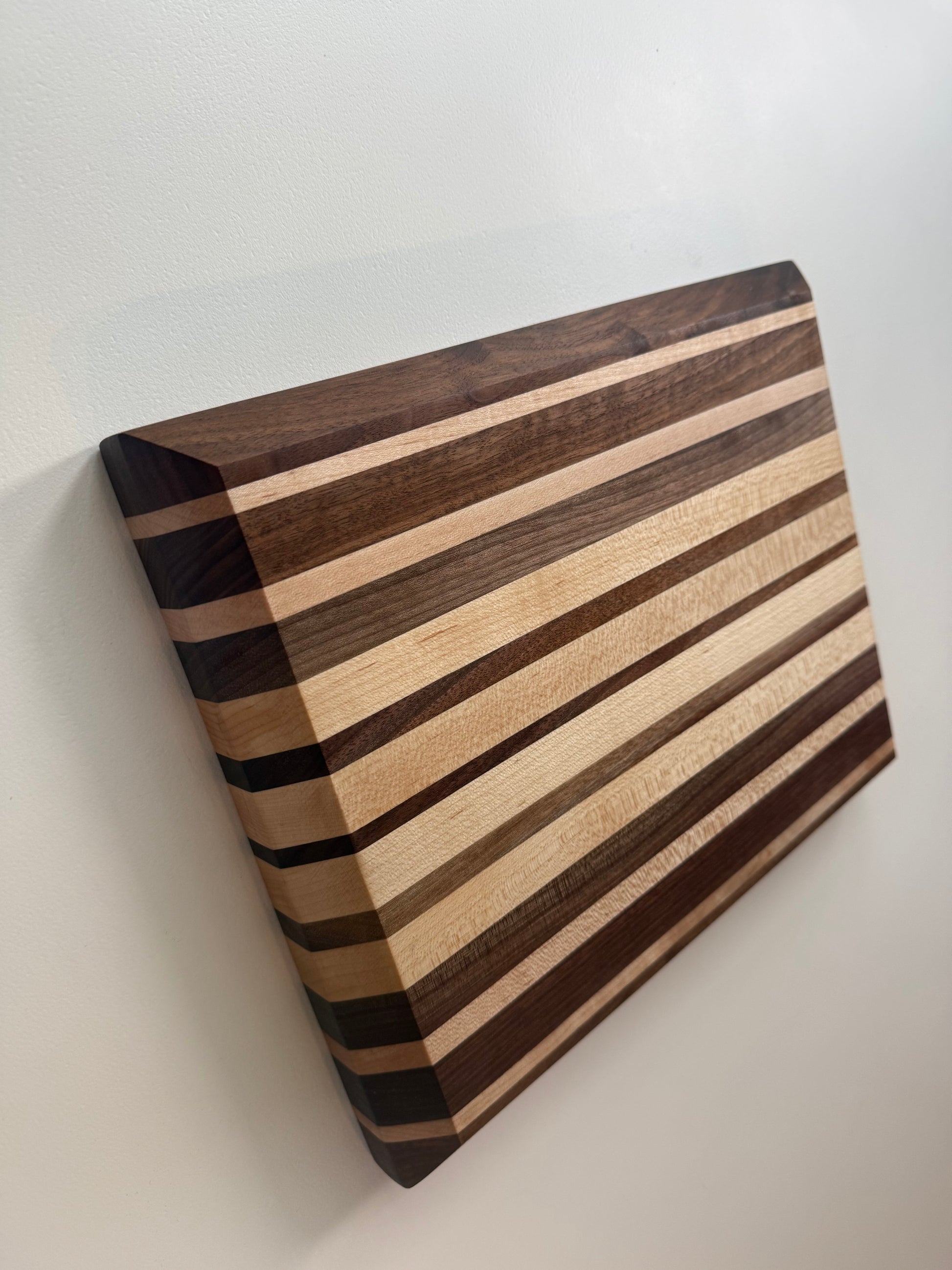 Wooden cutting board with striped pattern on a white background