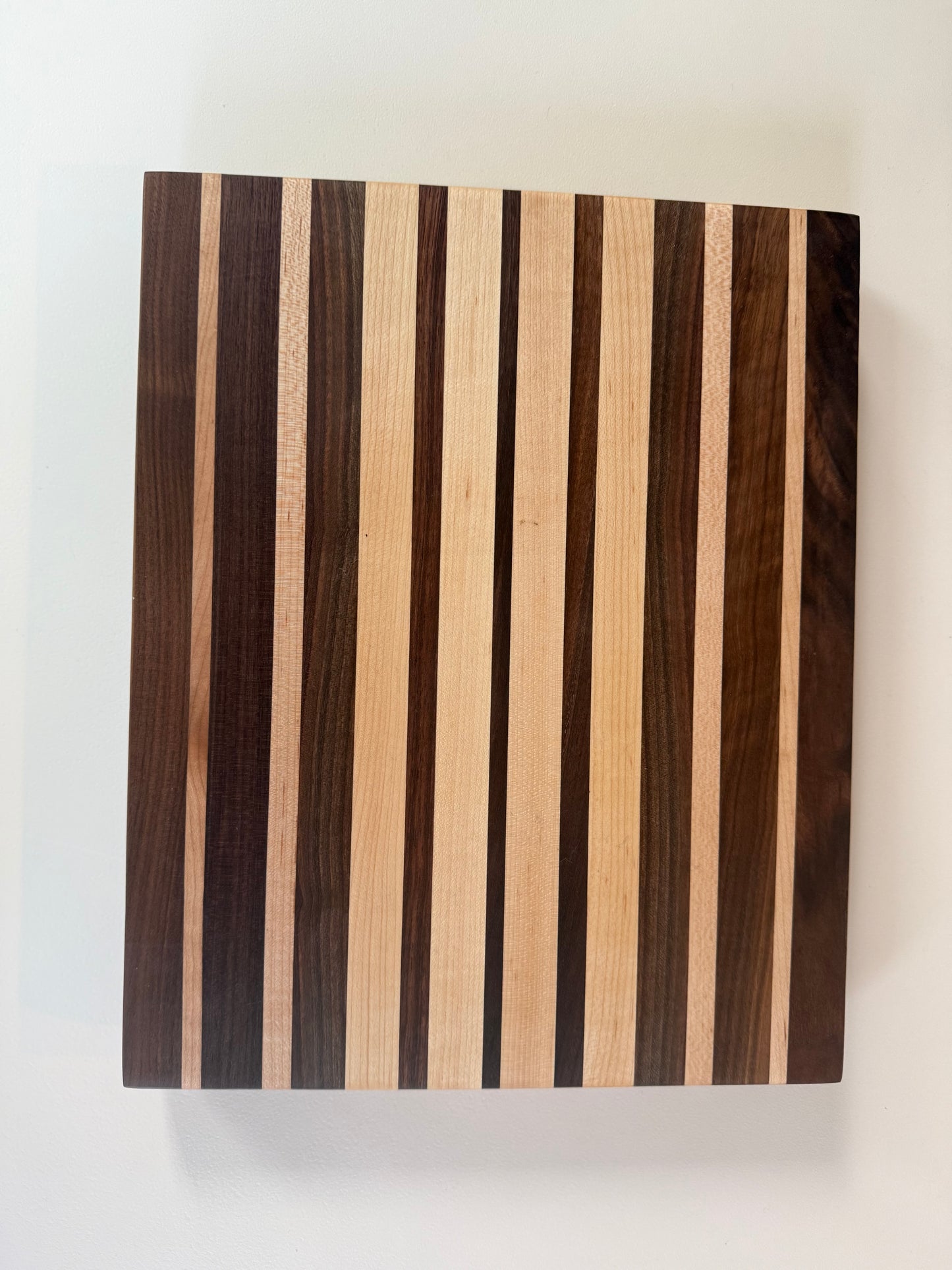 Wooden cutting board with striped pattern on a white background