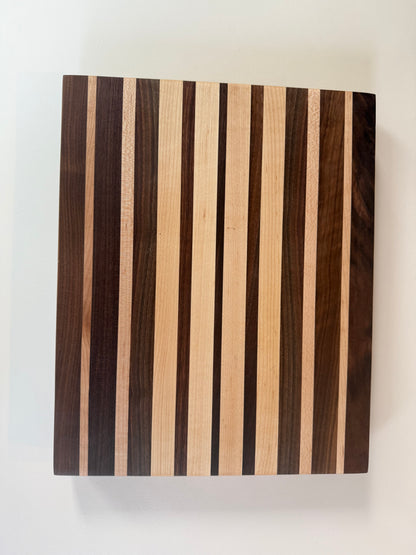 Wooden cutting board with striped pattern on a white background