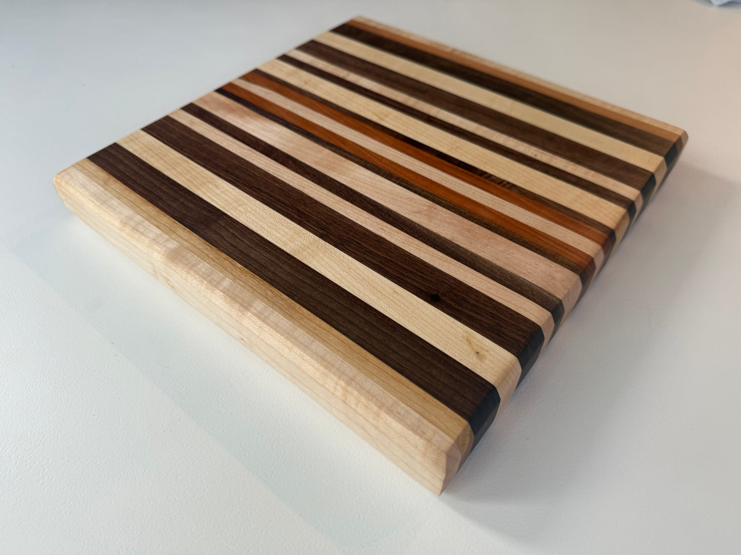 Wooden cutting board with striped pattern on a white background