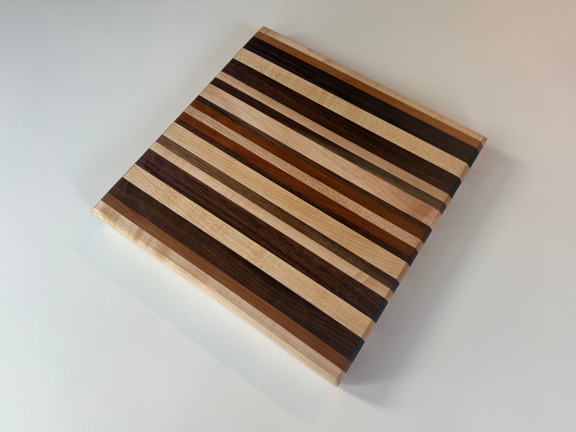 Wooden cutting board with striped pattern on a white background