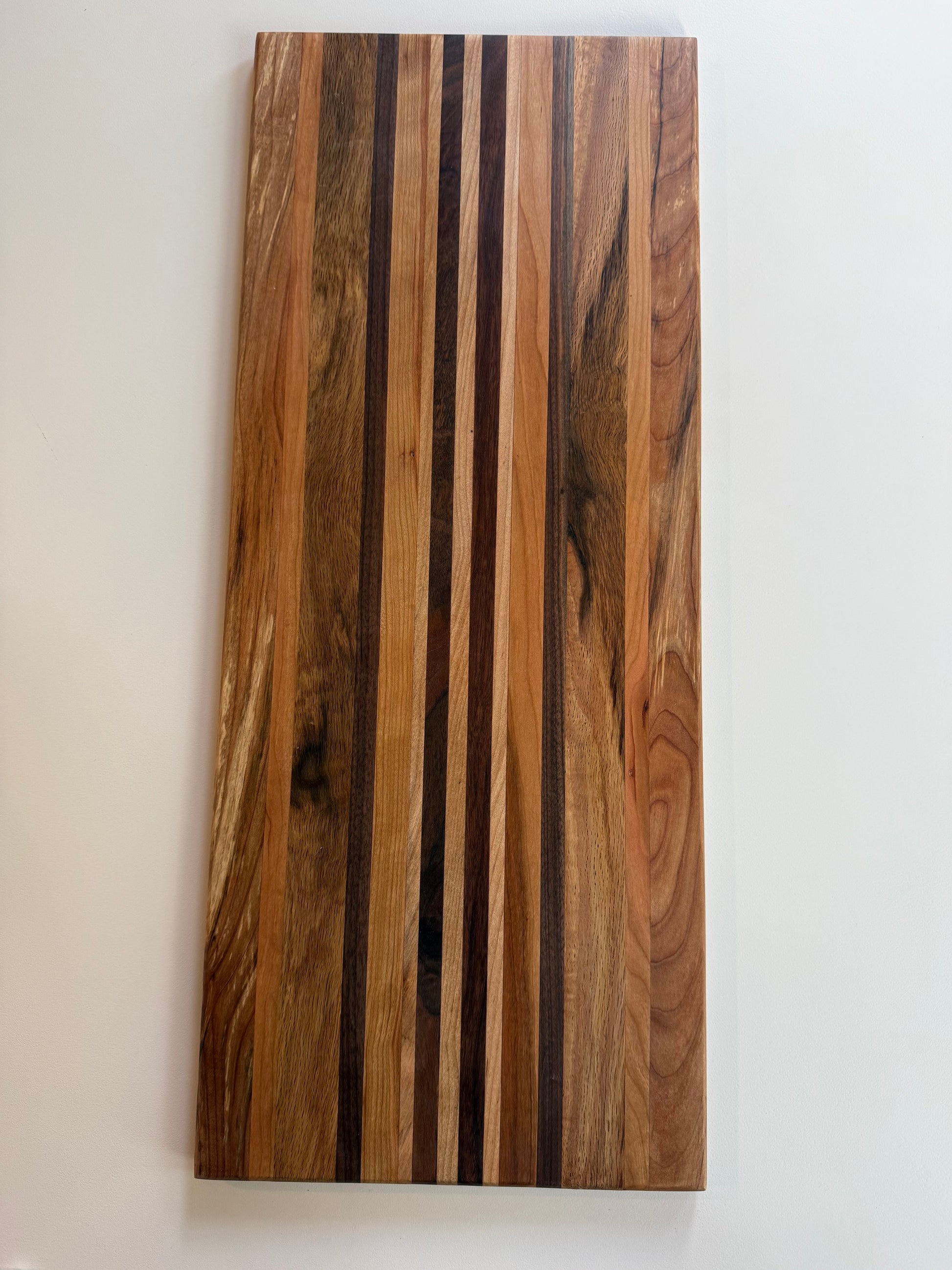 Wooden cutting board with a striped pattern