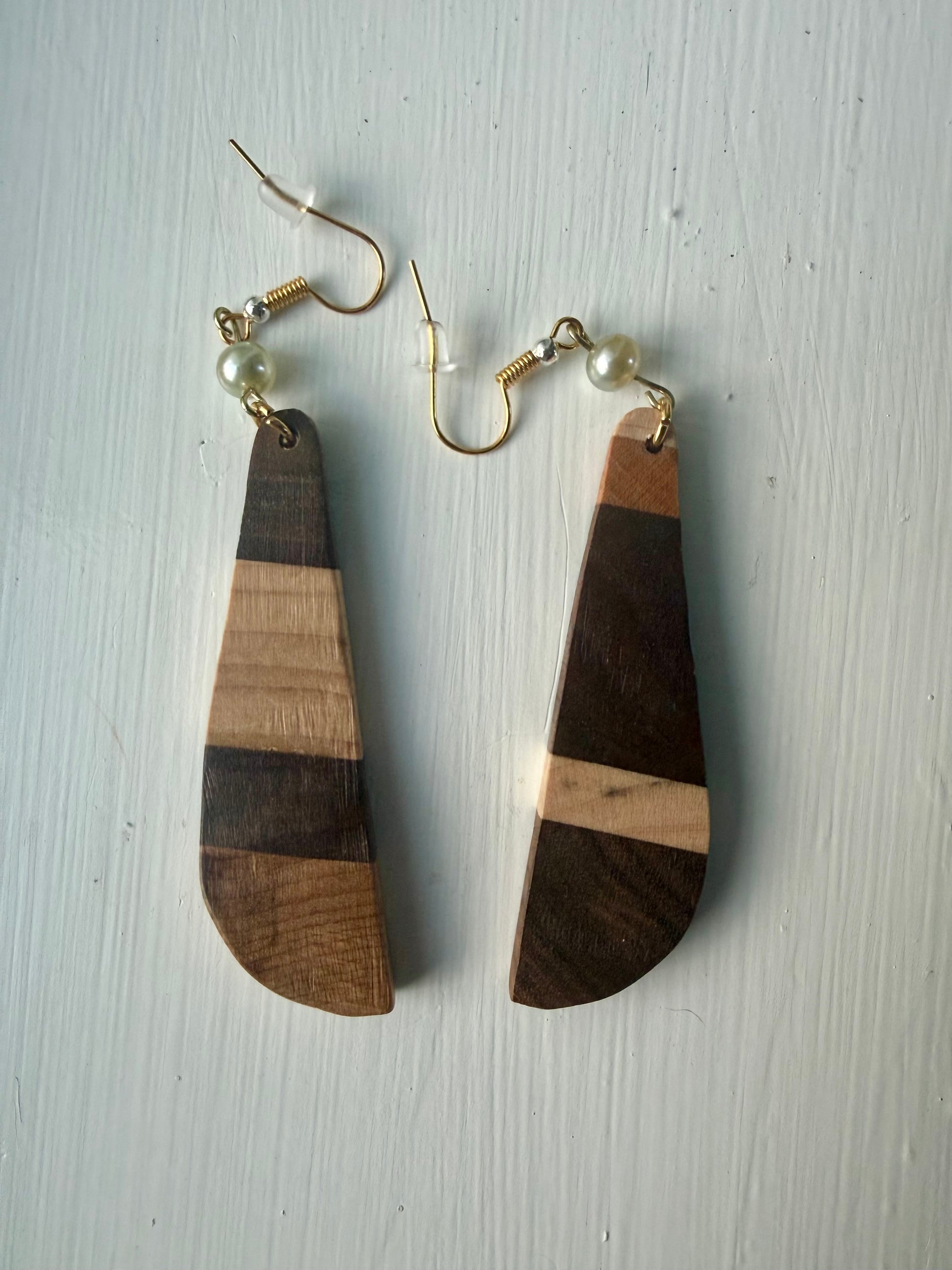 Striped wooden earrings on a white background
