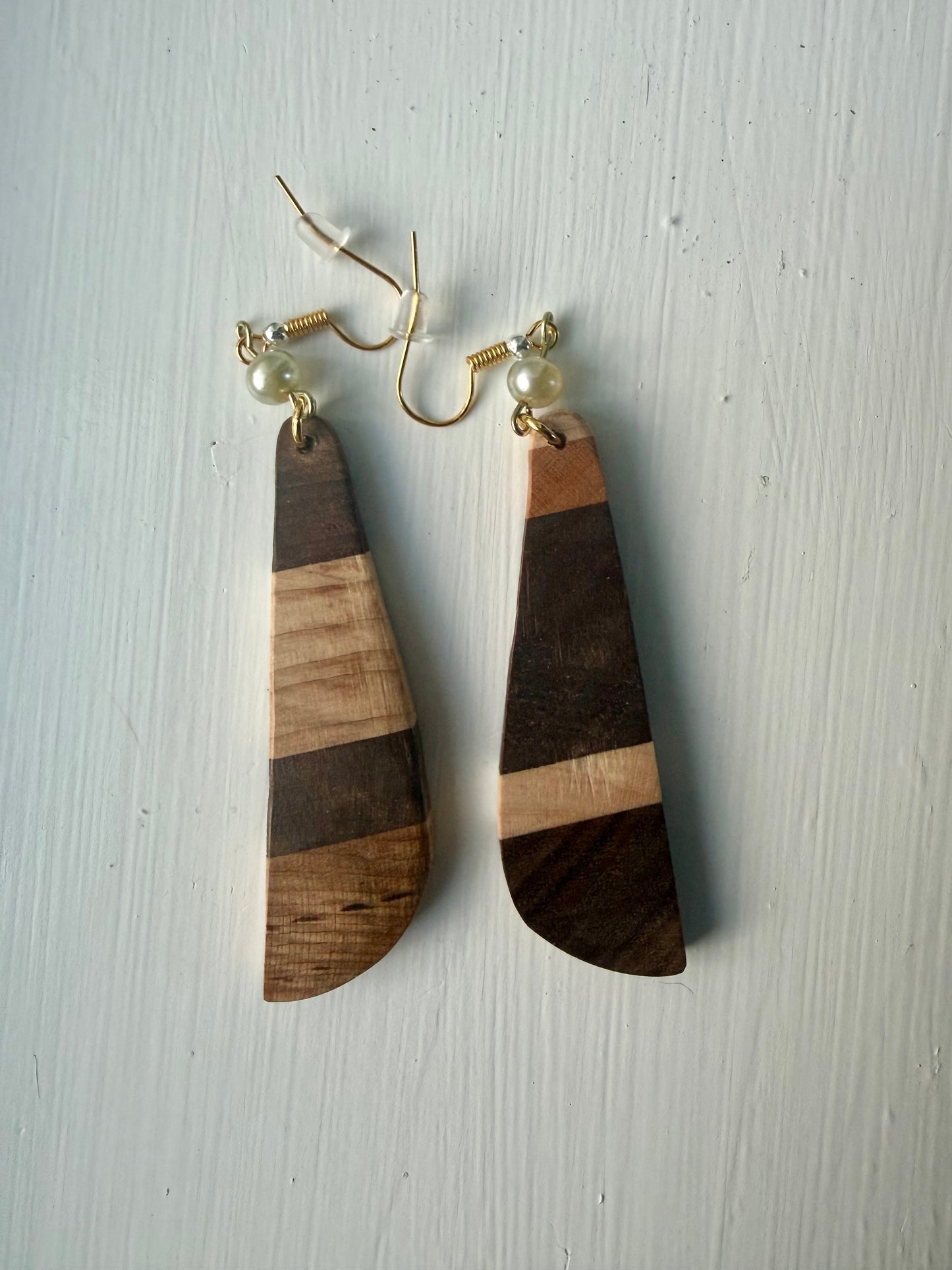 Striped wooden earrings on a white background