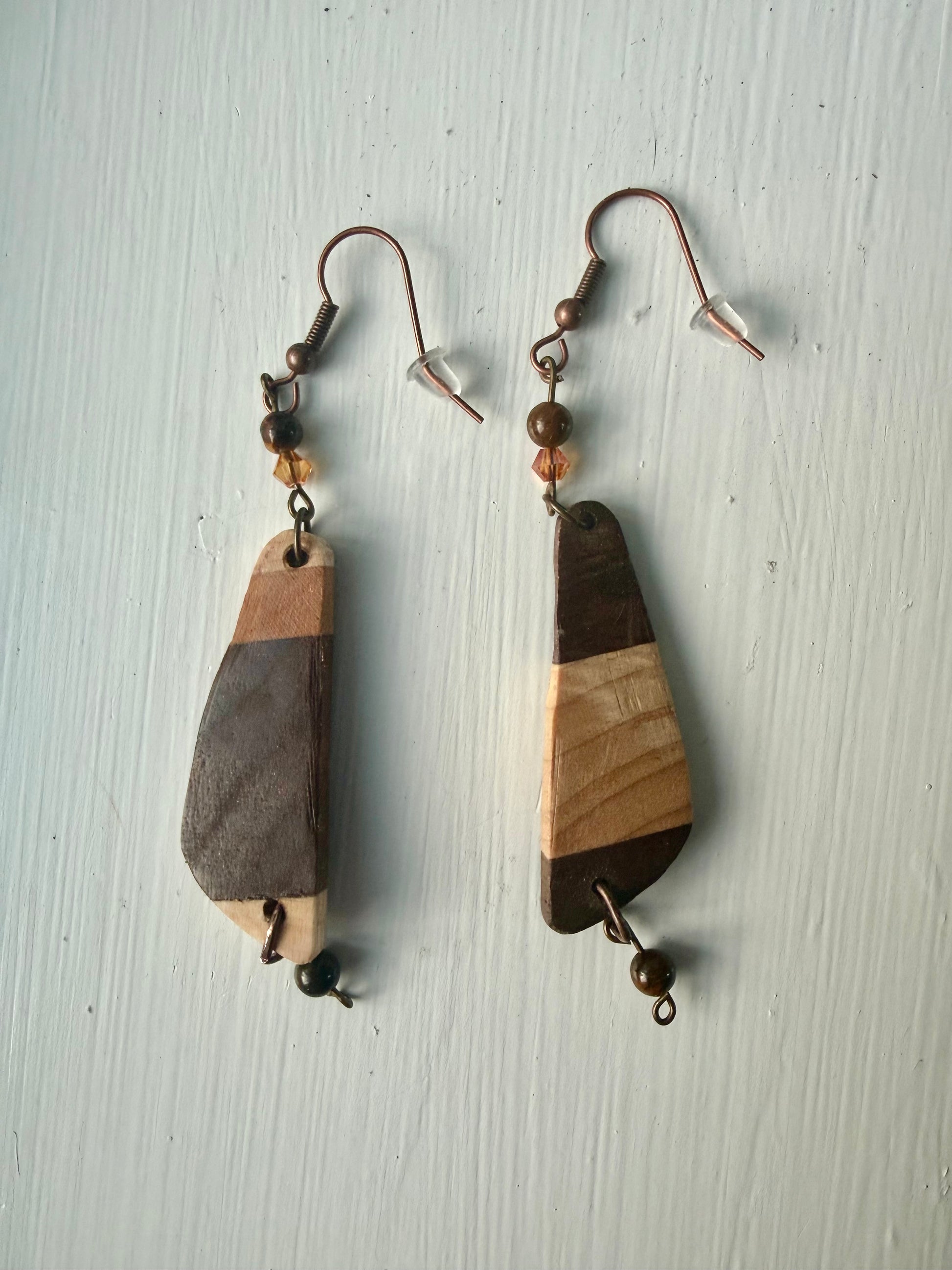 Striped wooden earrings on a white background