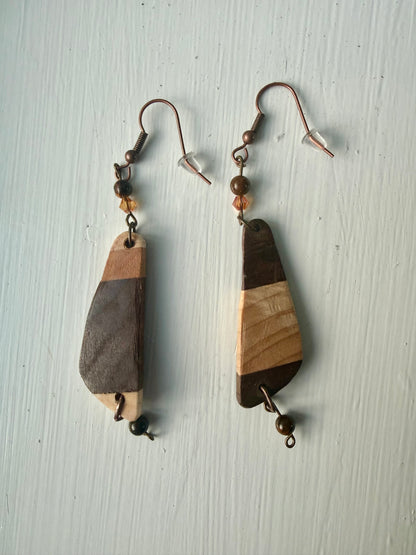 Striped wooden earrings on a white background