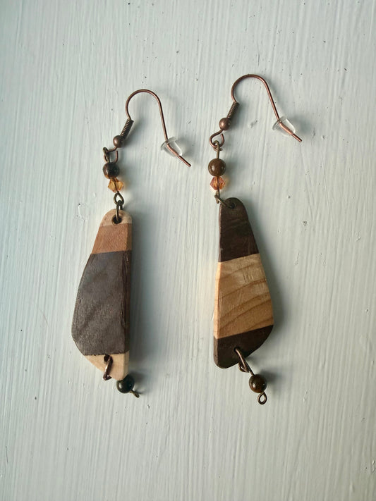 Striped wooden earrings on a white background