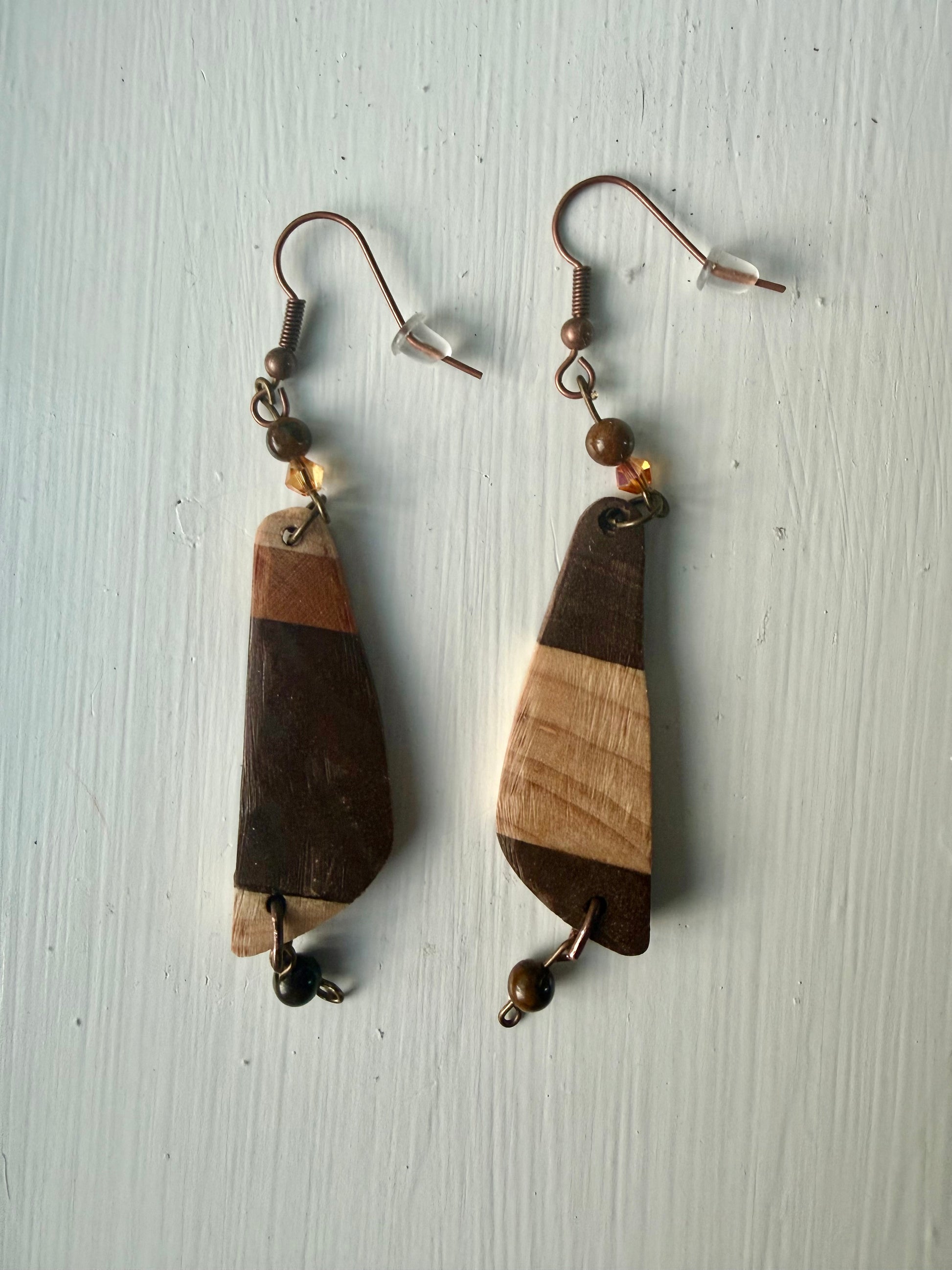 Striped wooden earrings on a white background