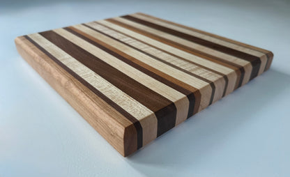 Wooden cutting board with striped pattern on a white background