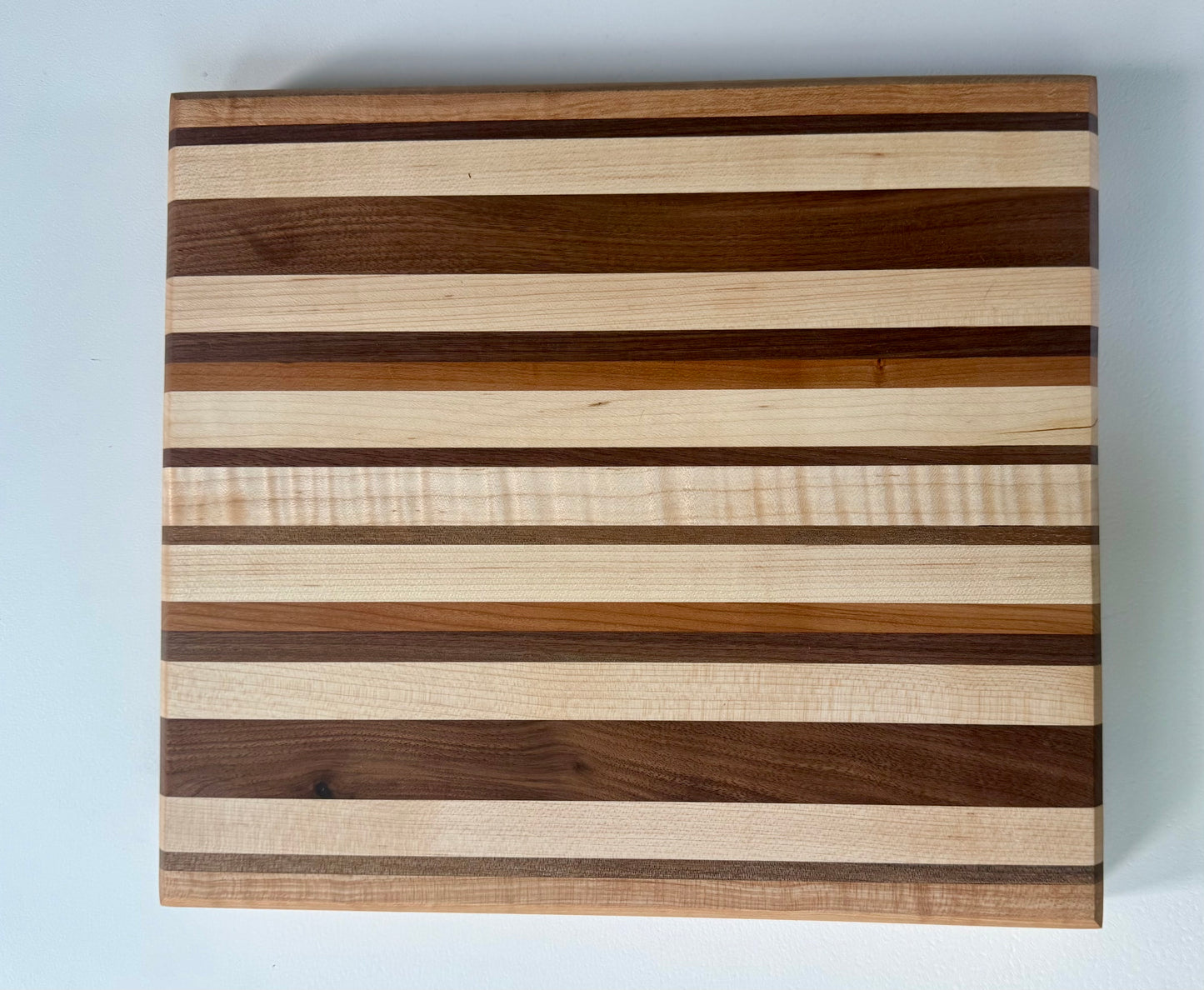 Wooden cutting board with striped pattern on a white background