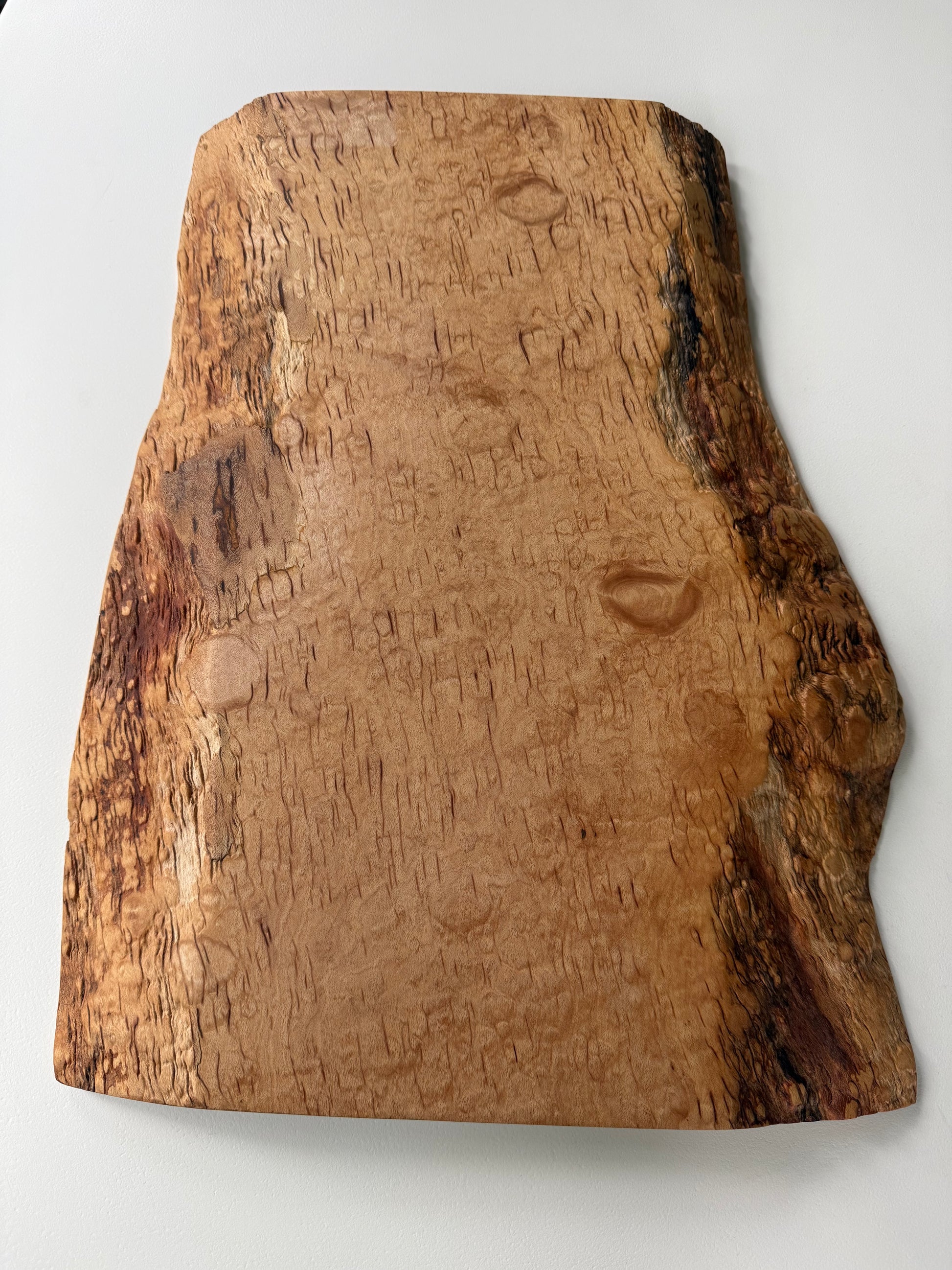Wooden flame maple charcuterie board with natural grain