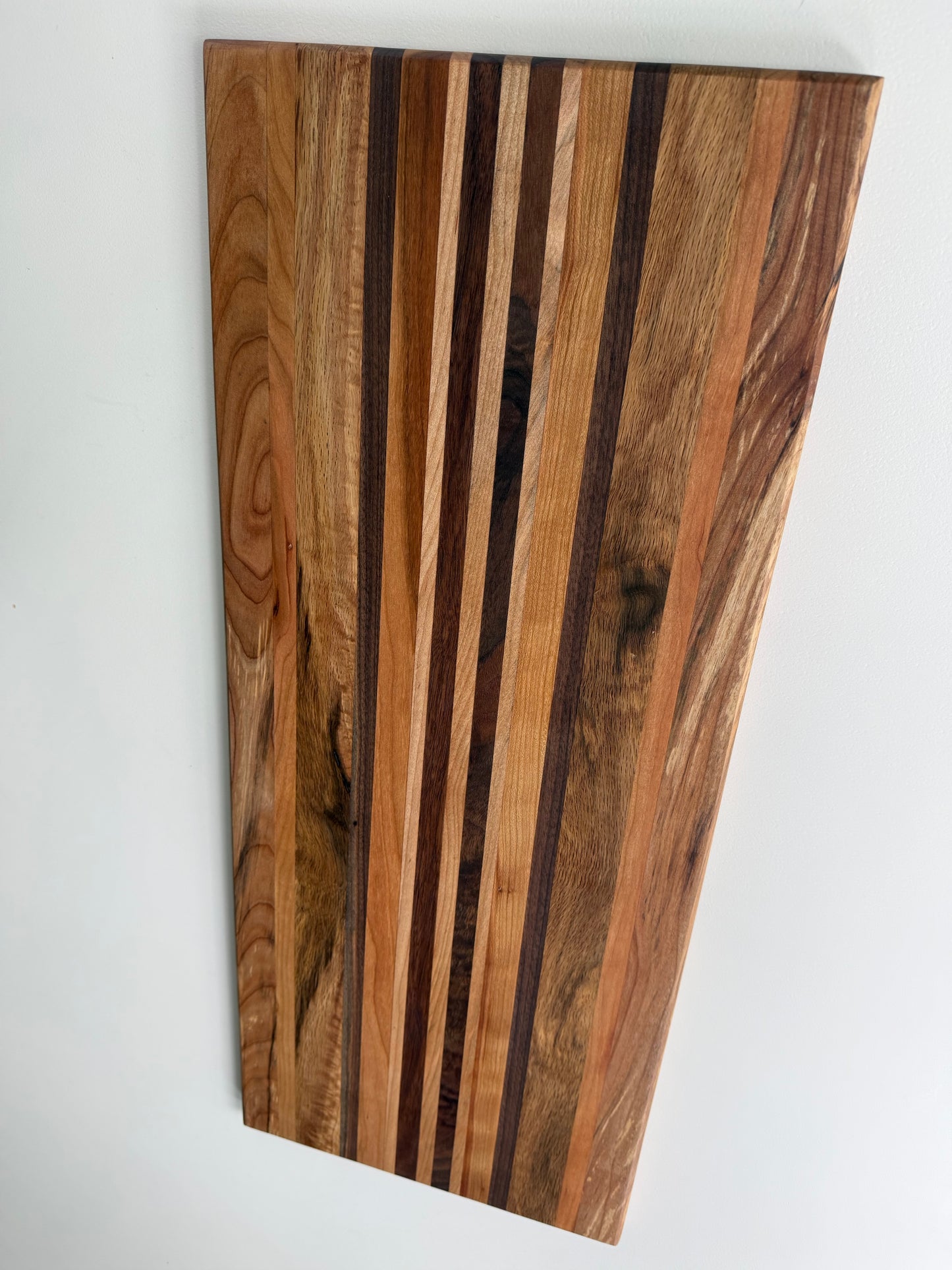Wooden cutting board with a striped pattern