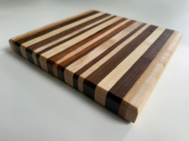 Wooden cutting board with striped pattern on a white background