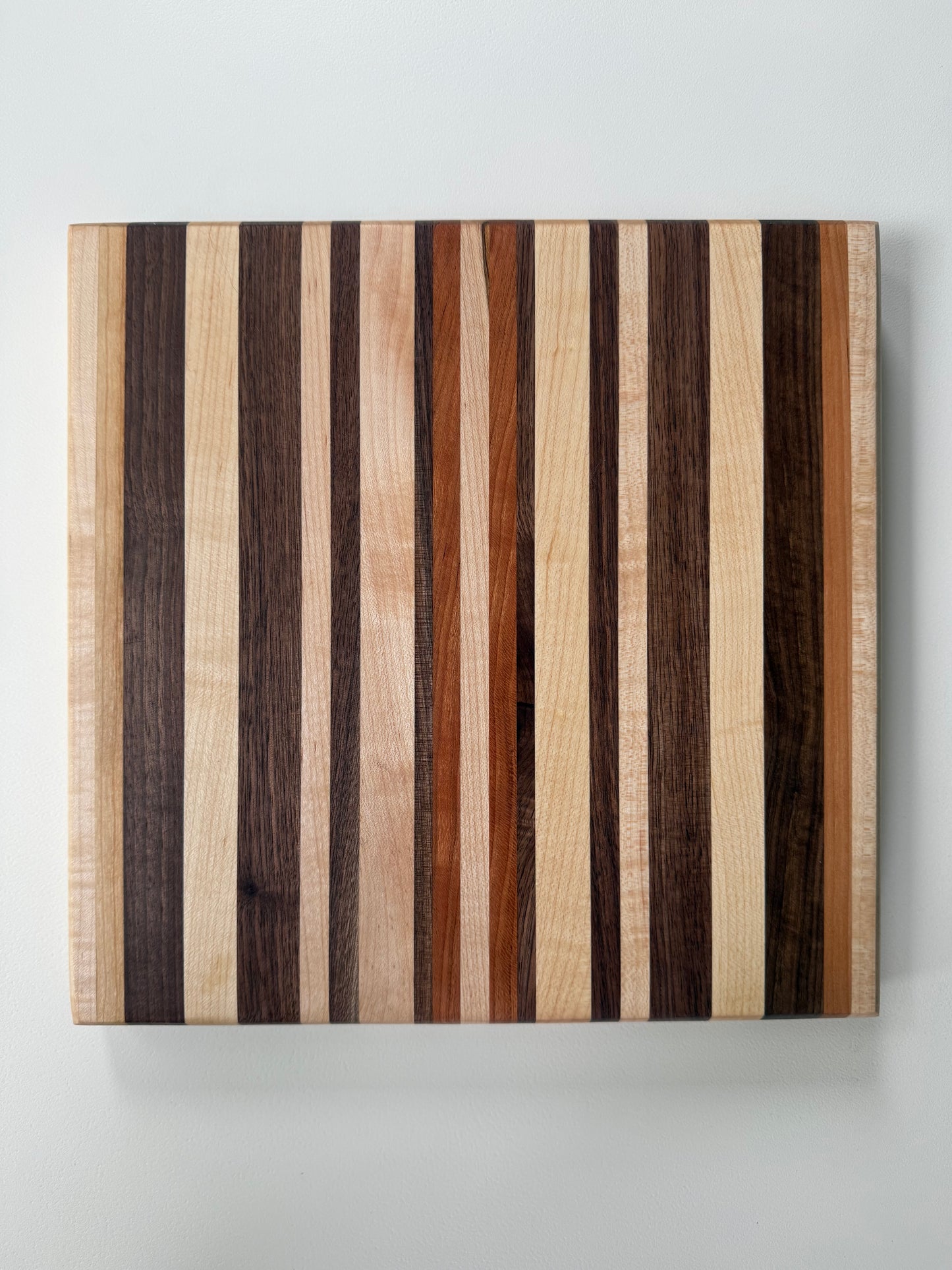 Wooden cutting board with striped pattern on a white background