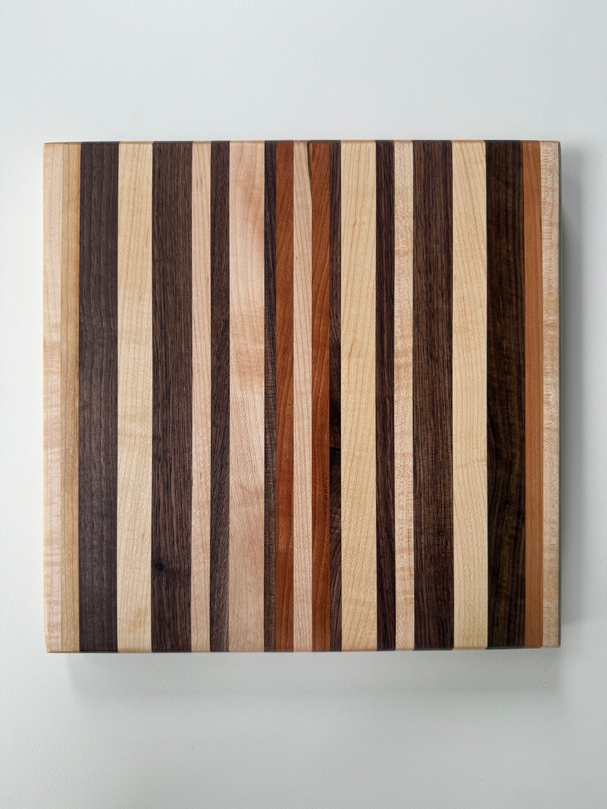 Wooden cutting board with striped pattern on a white background