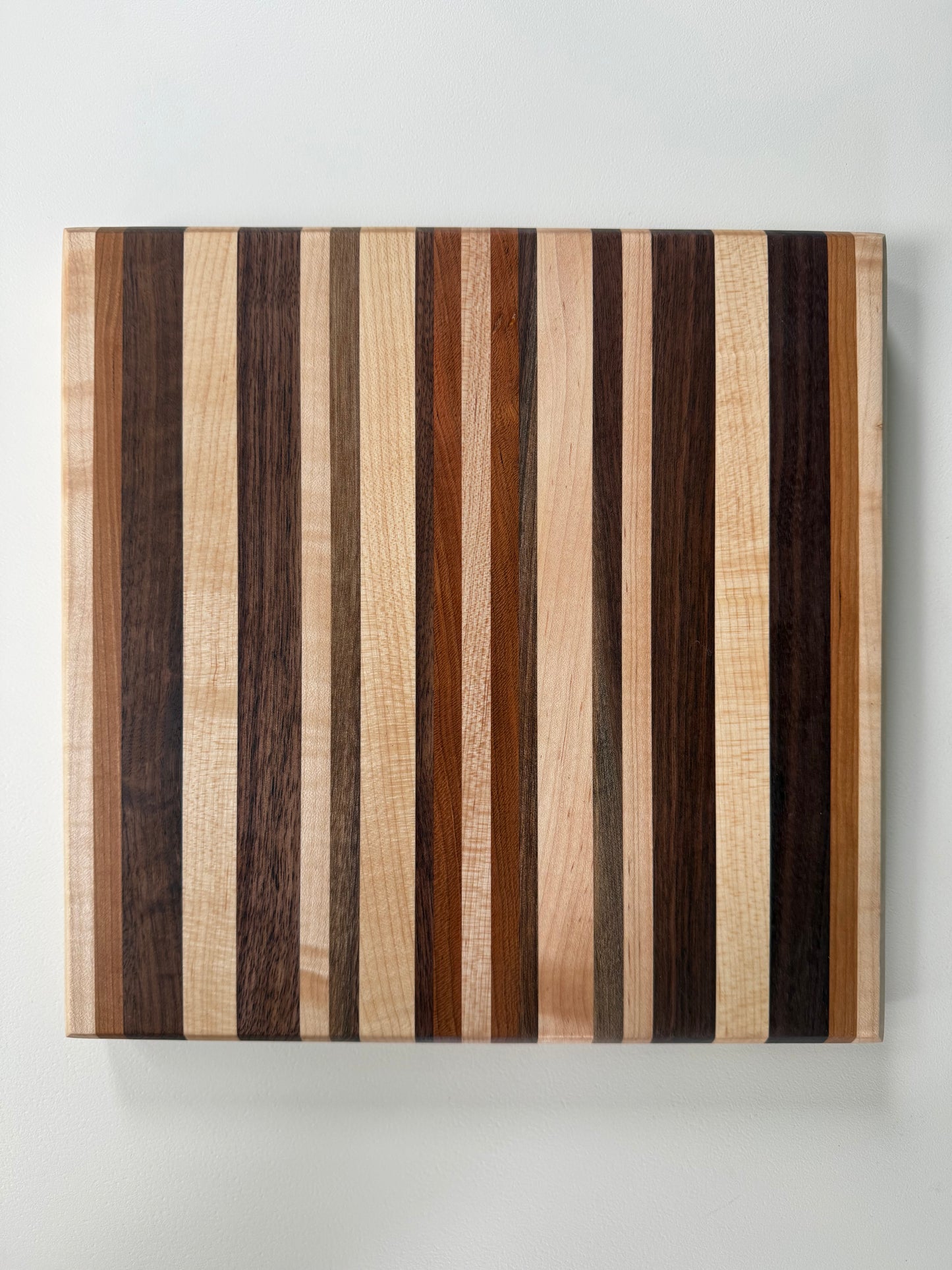 Wooden cutting board with striped pattern on a white background