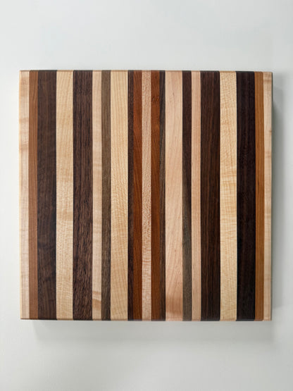 Wooden cutting board with striped pattern on a white background
