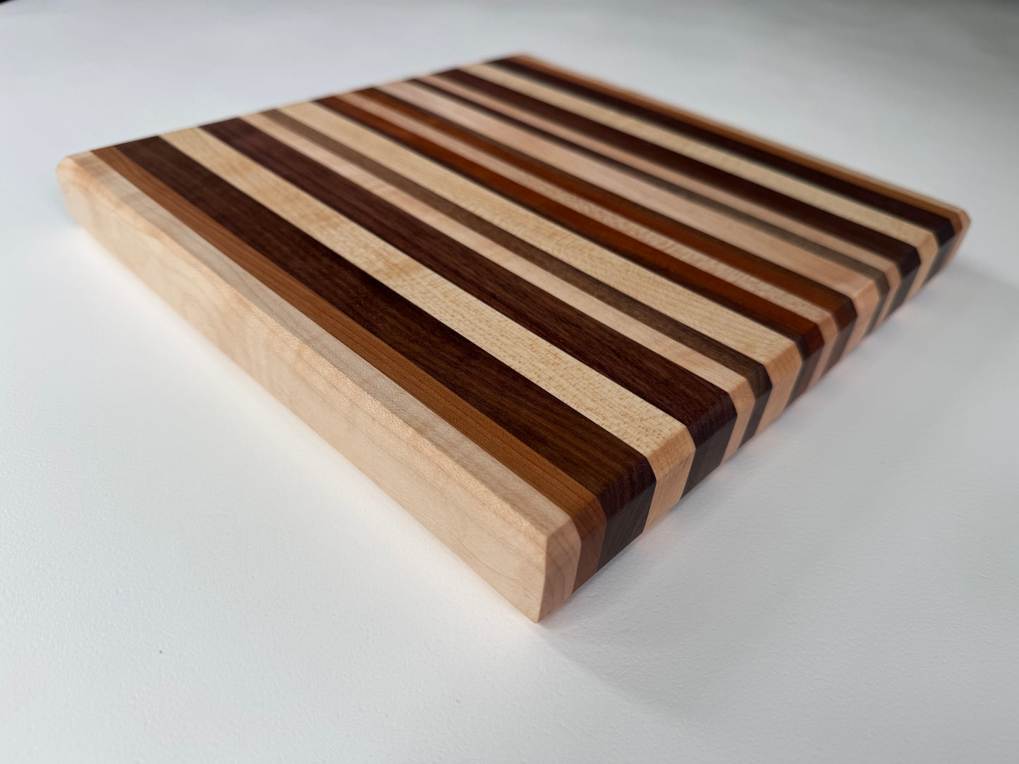 Wooden cutting board with striped pattern on a white background
