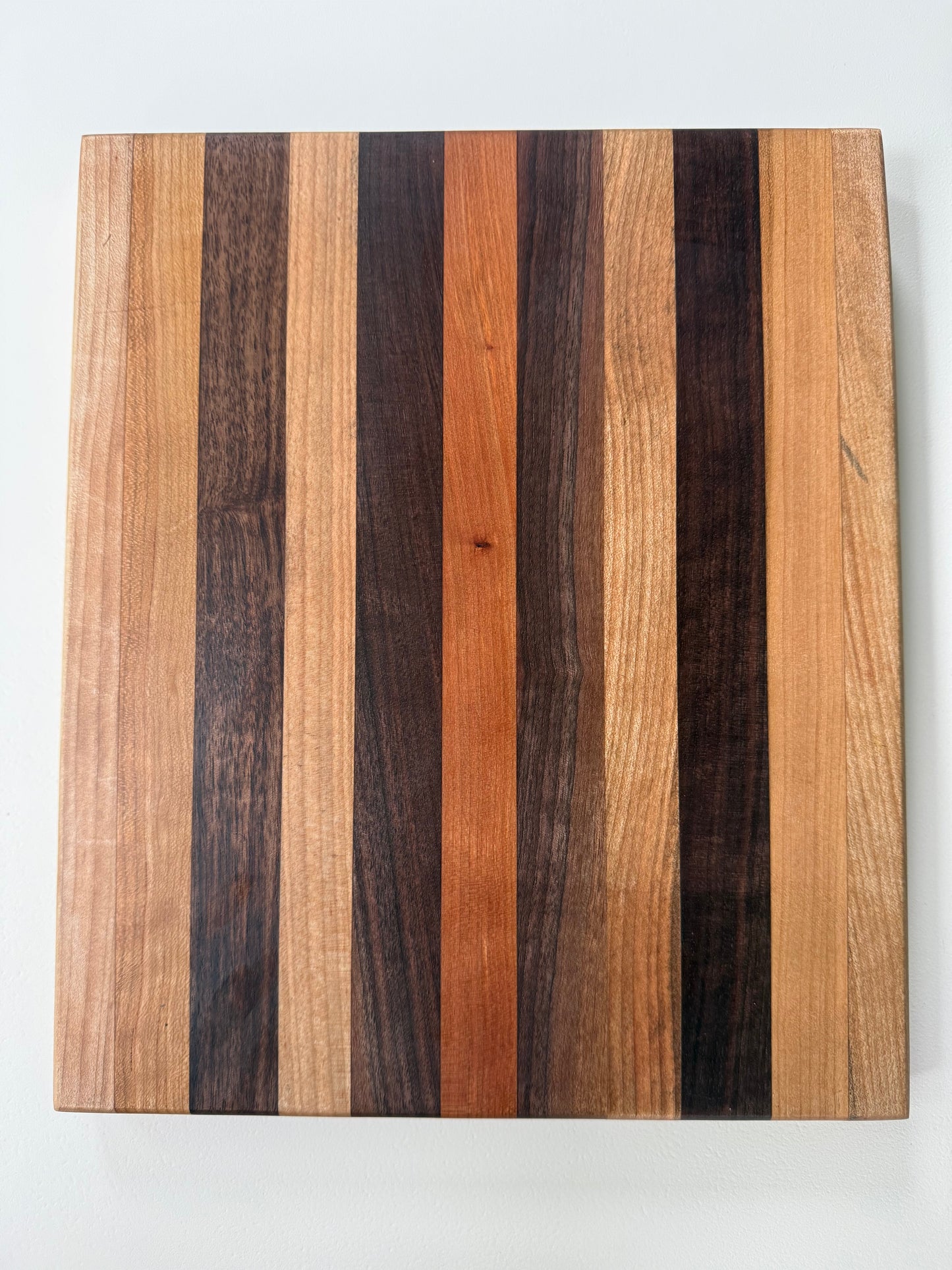 Wooden cutting board with striped pattern on a white background