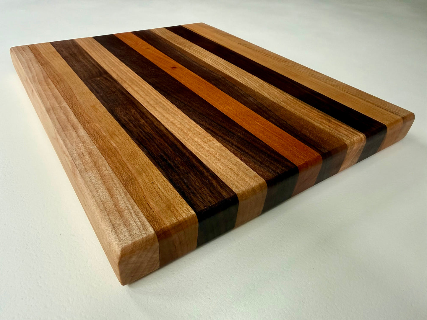 Wooden cutting board with striped pattern on a white background