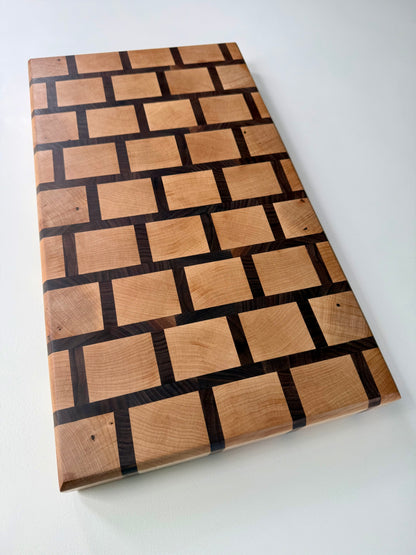 Wooden cutting board with a checkered pattern on a white background
