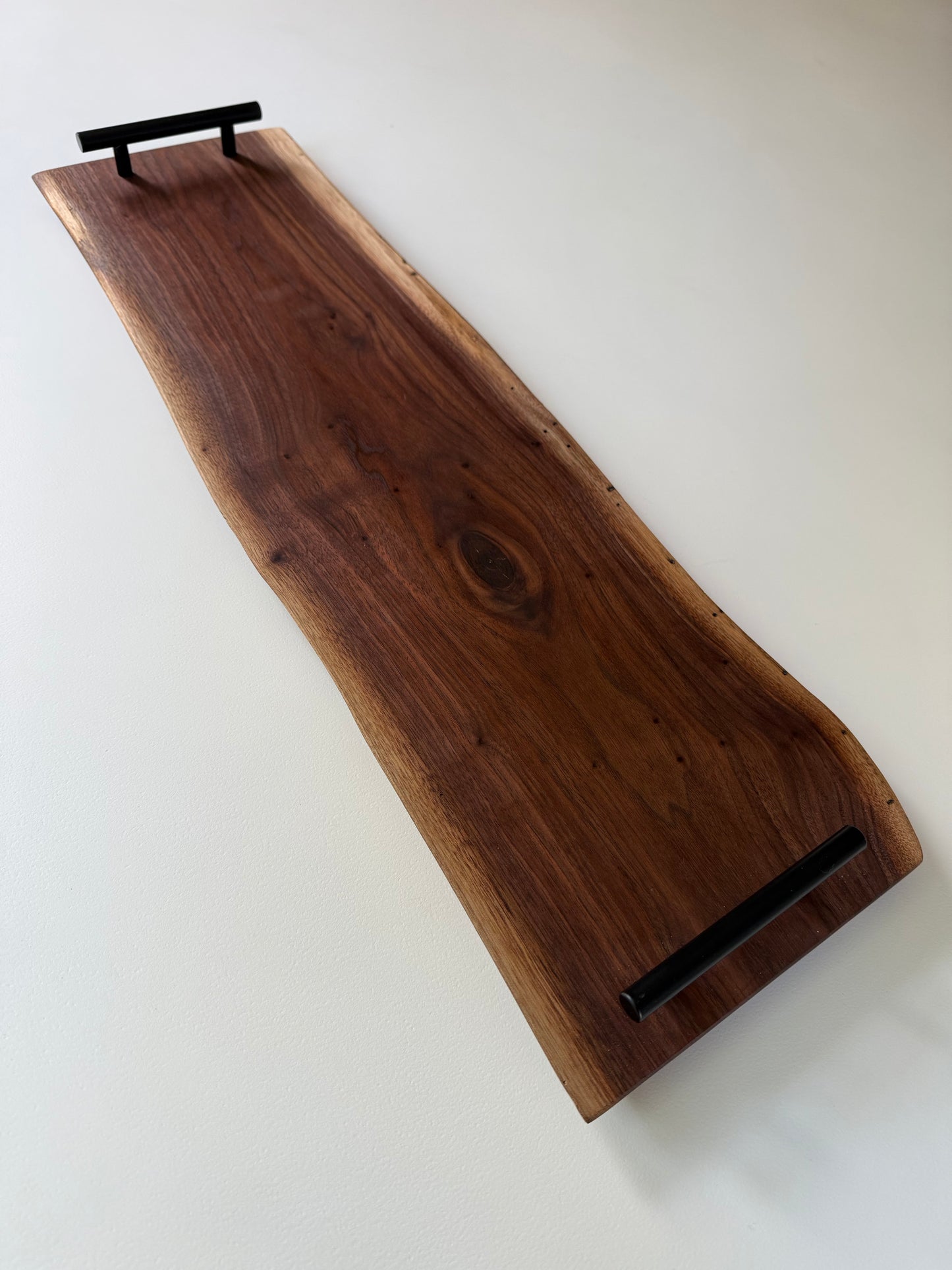 Spalted walnut charcuterie board with black handles 